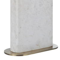 A white marble table lamp base with a natural honed finish, featuring a classic E26 socket, a dimmer switch, and an off-white linen shade, complemented by a brushed brass finished iron stem.