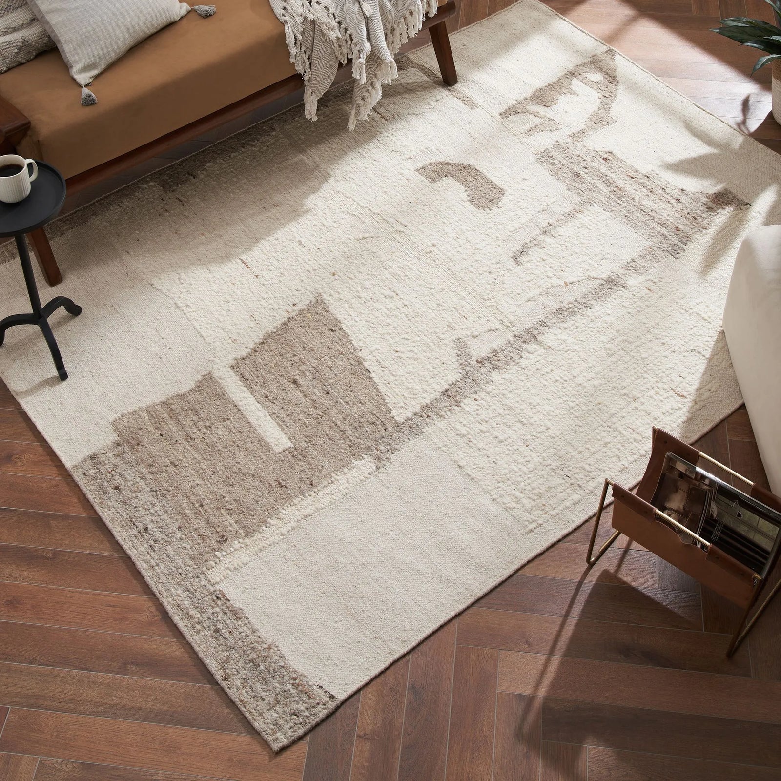 Beige and brown patterned rug on a wooden floor with furniture around