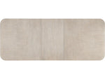 Top of a rectangular dining table with a light wood finish on a white background