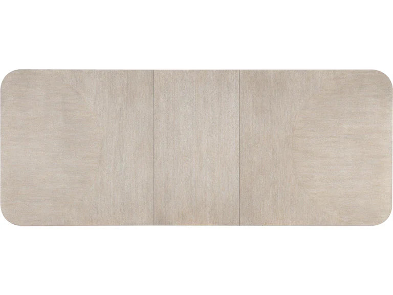 Top of a rectangular dining table with a light wood finish on a white background