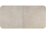 rectangular dining table with a light wood finish on a white background