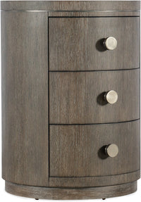 Round nightstand with three drawers on a white background