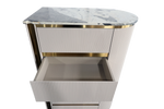 Decorative side table with marble top and ribbed white base on a white background