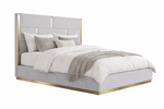 Gray upholstered bed with gold accents on a white background