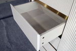 Metallic tray with gold rim on a textured surface