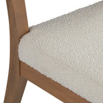 Close-up of a textured beige cushion on a wooden chair