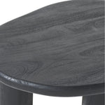 A matte black finish coffee table made of solid wood, with a flat, circular top and three sturdy legs.