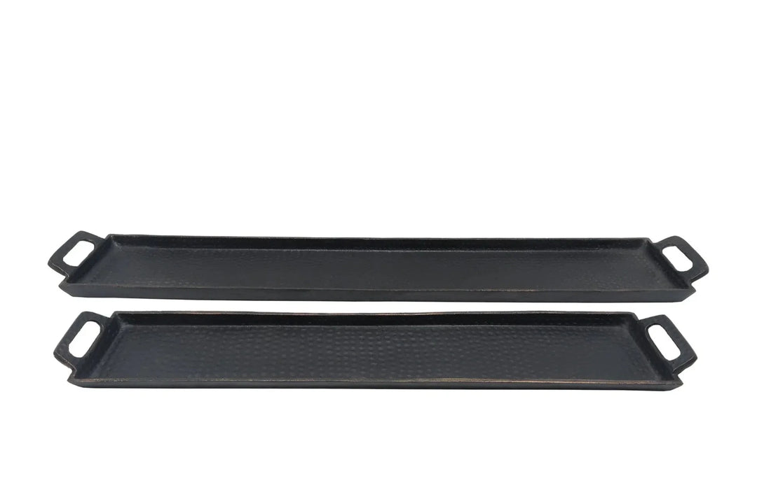 Two black griddle pans on a white background