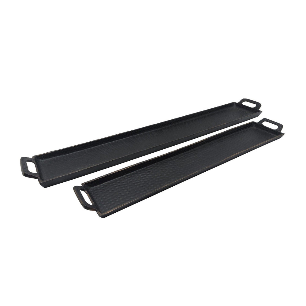 Two black griddle pans on a white background