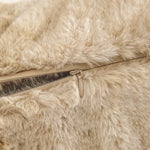Close-up of a beige fur jacket with a zipper