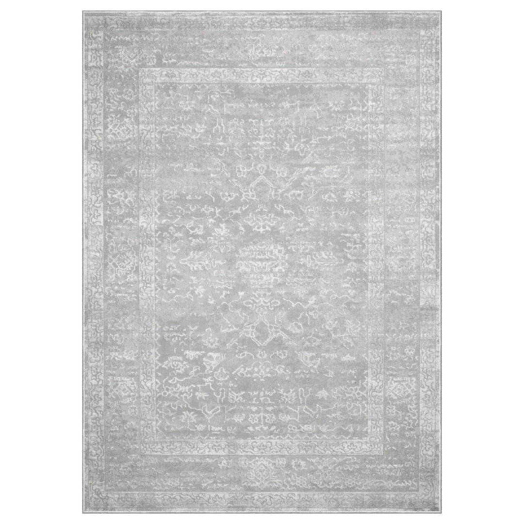 Gray area rug with subtle pattern on a white background