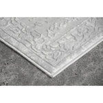 Textured gray rug on a concrete floor