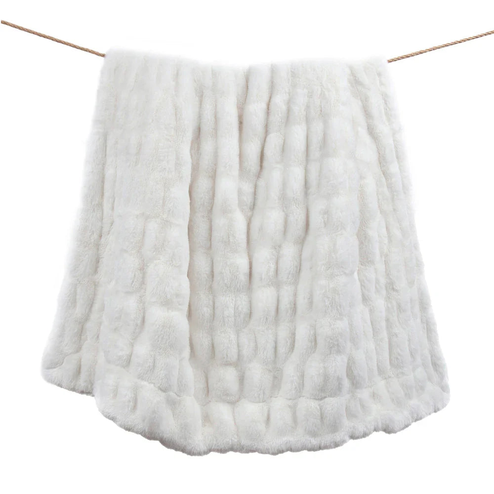 White textured blanket draped over a wooden stick on a white background