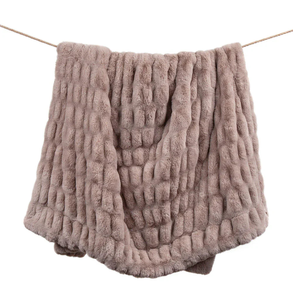 Textured pink blanket draped over a white background