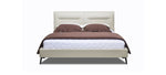 A beige upholstered headboard bed with brown leather-like fabric on the headboard and a white mattress.
