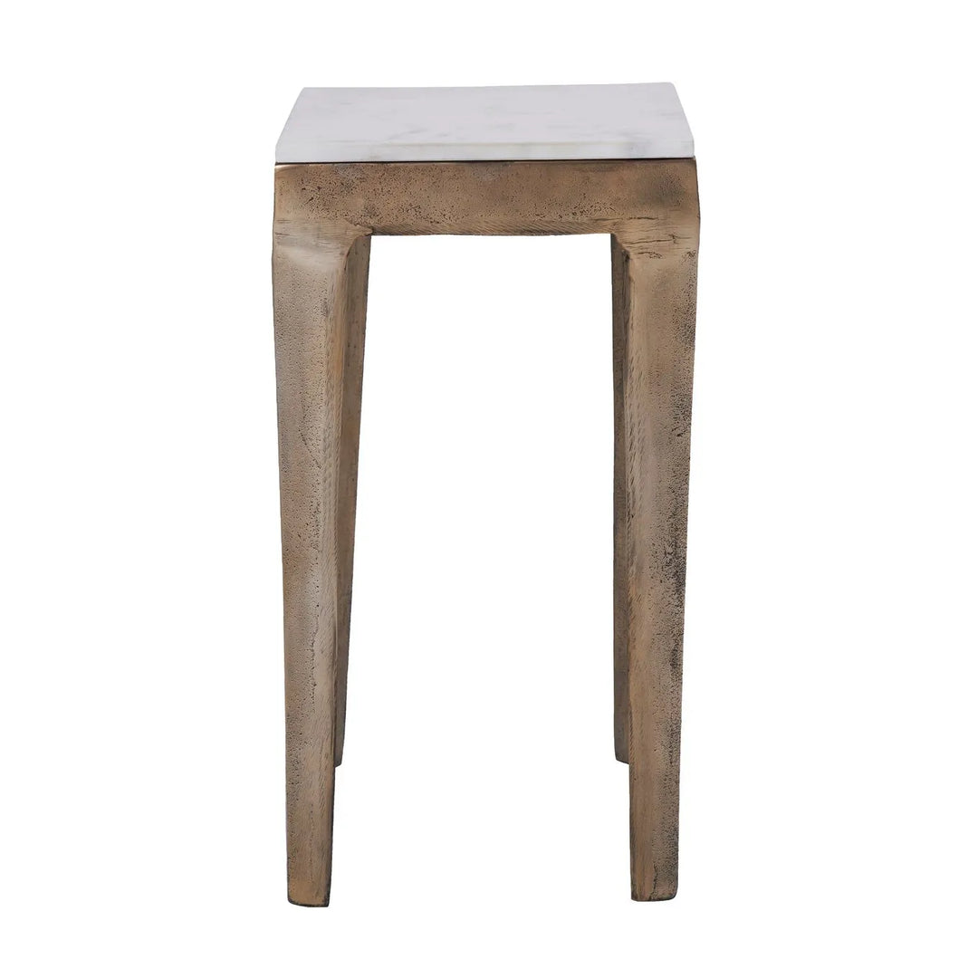 A square brass end table with a white marble top, having visible grain and patterns on the surface.