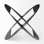 A round, black metal decorative object with a geometric design.