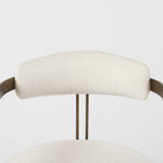 Chair with white cushioned seat and backrest on a gold metal frame against a white background