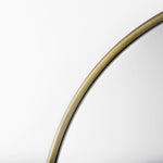 Close up to a full-length mirror with gold finished on a white background