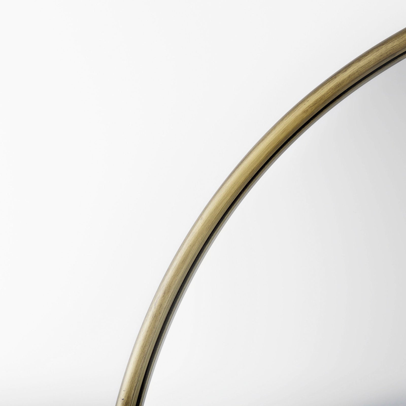 Close up to a full-length mirror with gold finished on a white background