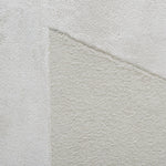 Close-up of a textured light gray fabric with a subtle pattern
