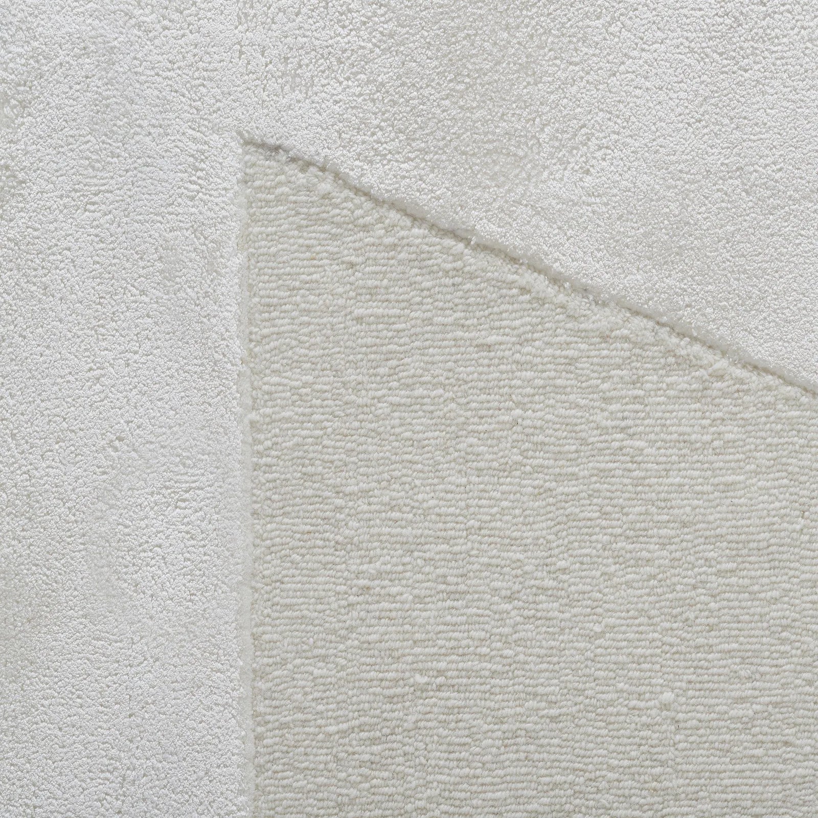 Close-up of a textured light gray fabric with a subtle pattern