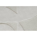 Close-up of a textured gray rug with geometric patterns