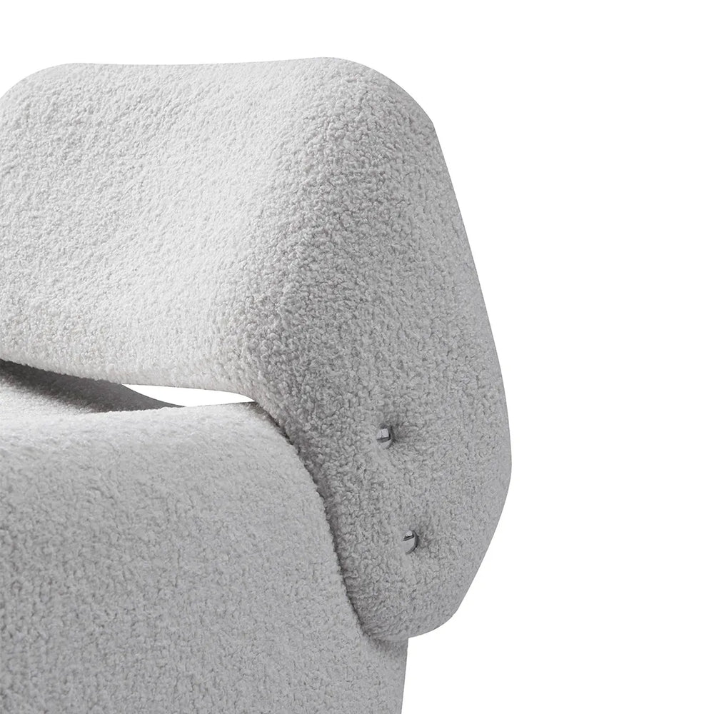 Close-up of a textured gray chair armrest on a white background