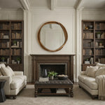Living room with beige sofas, a wooden ottoman, and bookshelves.