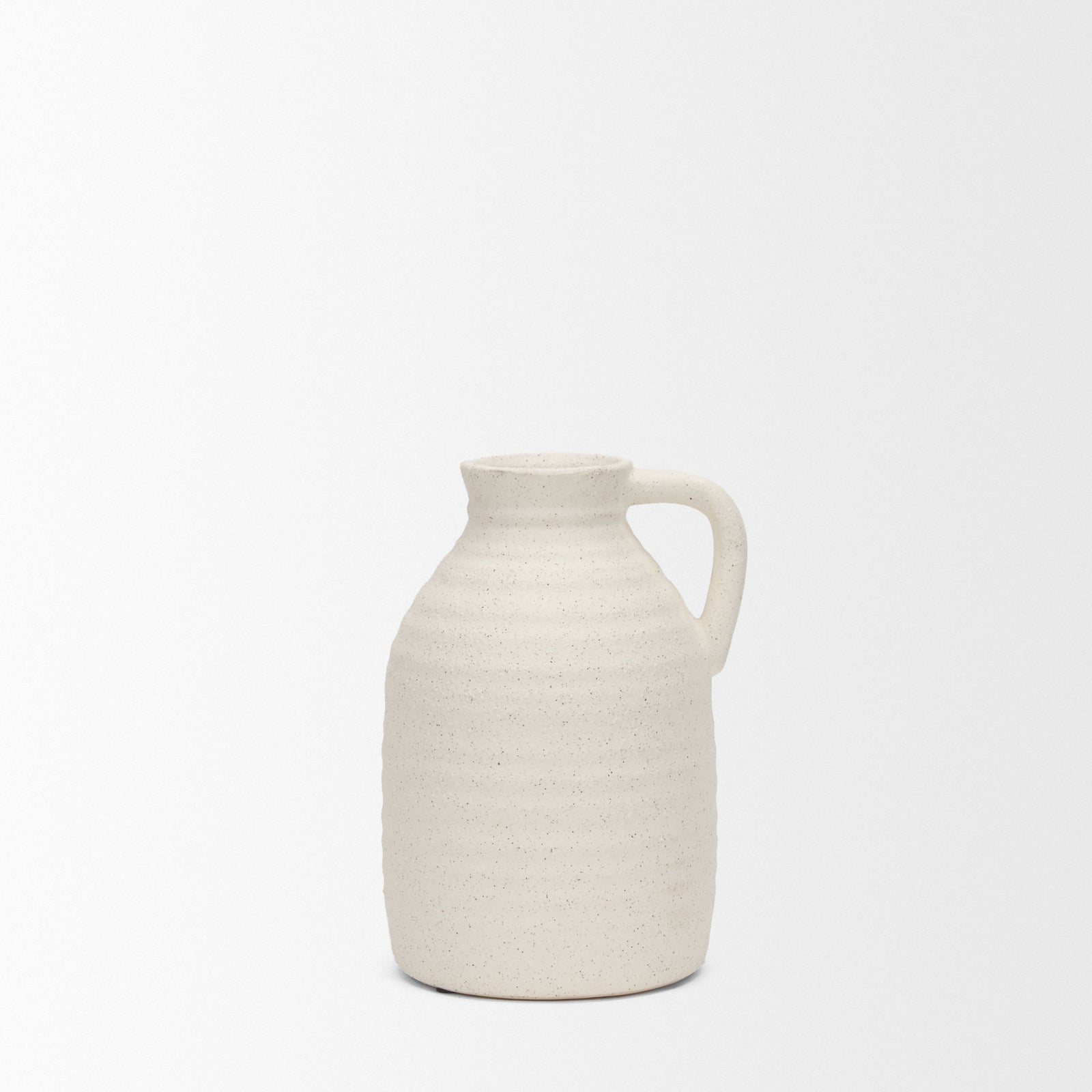 White ceramic pitcher on a light beige background