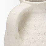 Close-up of a textured ceramic vase on a white background