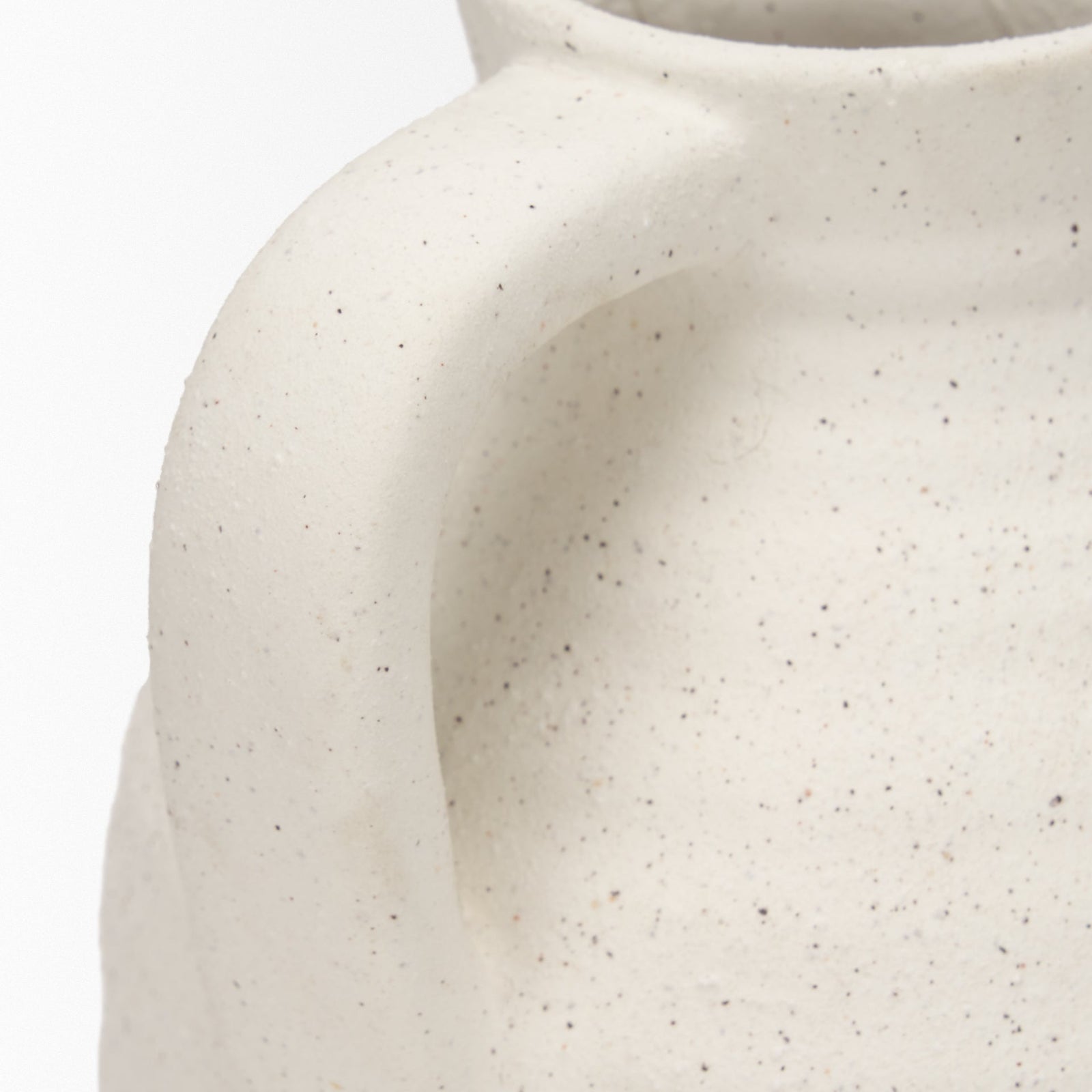 Close-up of a textured ceramic vase on a white background