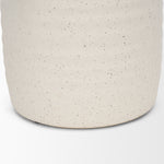 Close-up of a textured beige container on a white background