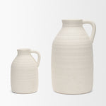 Two cream-colored ceramic jugs on a white background