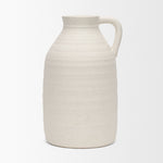 White ceramic pitcher on a light gray background