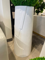 A white, textured, rounded planters of different sizes, each containing a spherical artificial green plant.
