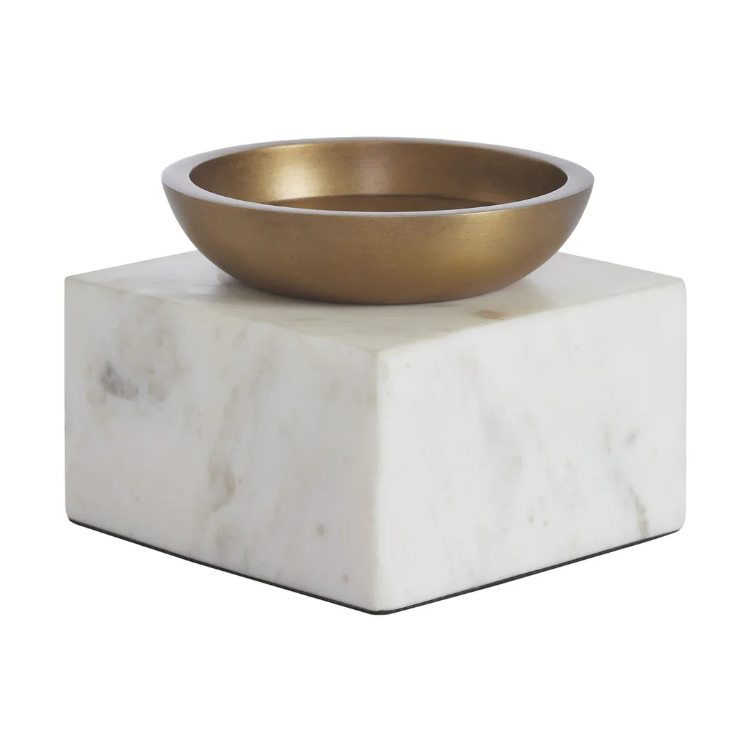 Bronze bowl on a marble pedestal against a white background