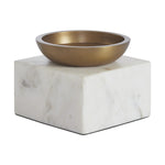 Bronze bowl on a marble pedestal against a white background