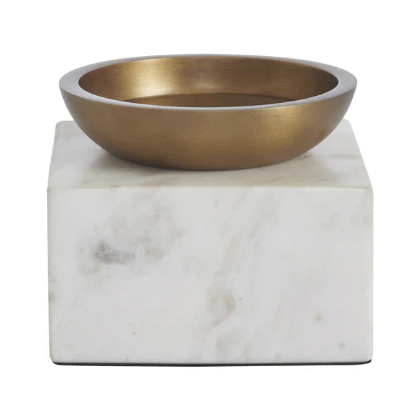 Brass bowl on a marble base against a white background