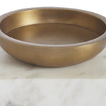 Gold bowl on a marble surface