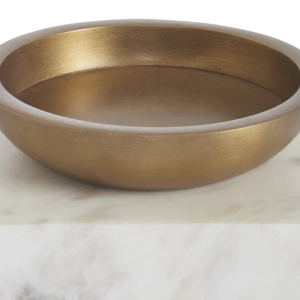Gold bowl on a marble surface