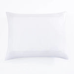 White pillow with decorative stitching on a white background