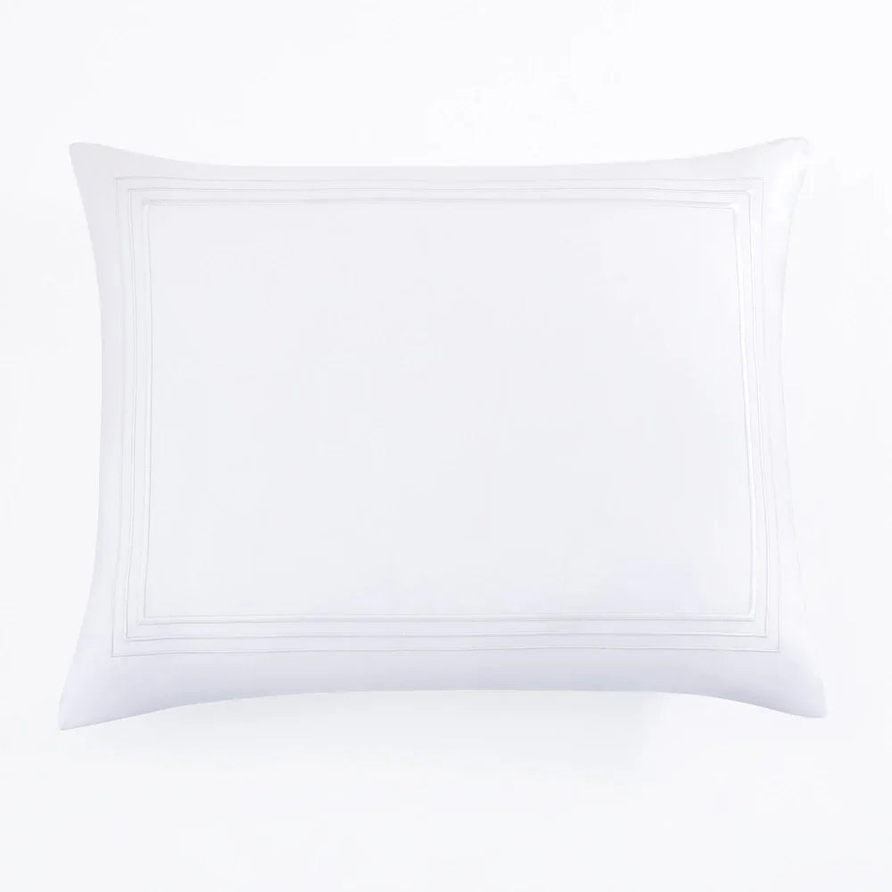 White pillow with decorative stitching on a white background