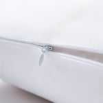 Close-up of a white pillow with a zipper on a light gray background
