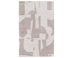 A grey and white geometric patterned area rug.