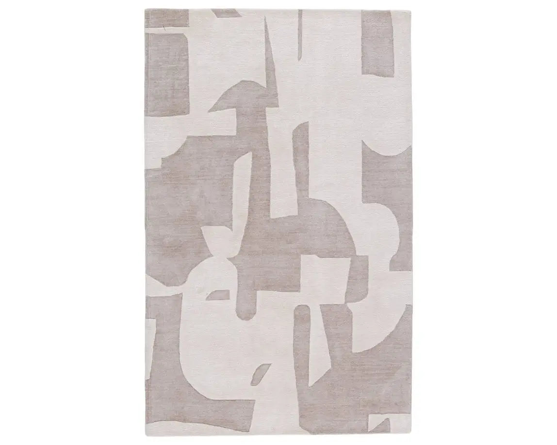 A grey and white geometric patterned area rug.