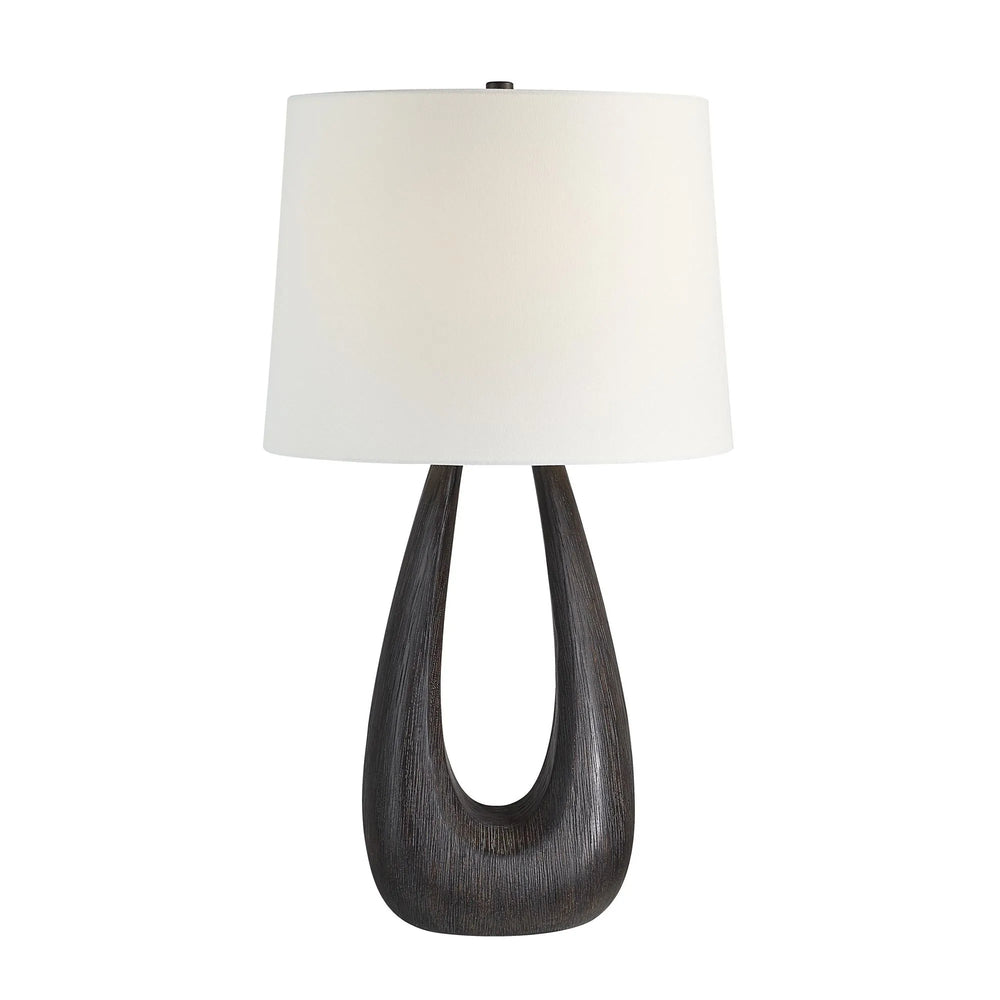 Table lamp with a dark wooden base and white lampshade on a white background