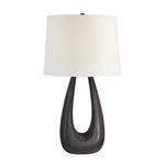 Table lamp with a dark wooden base and white lampshade on a white background