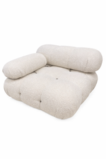 Beige cushion with quilted texture on a white background