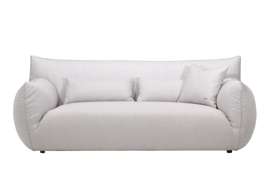 A plush Claudi sofa in a gray fabric, featuring a seamless cushion attached to the back and a sleek, modern design.